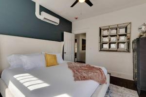 a bedroom with a white bed and a ceiling fan at Historic Apt Near Music Row-Hillsboro Village in Nashville