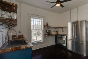 a kitchen with a stainless steel refrigerator and a window at Historic Apt Near Music Row-Hillsboro Village in Nashville