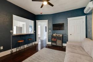 a living room with blue walls and a couch at Historic Apt Near Music Row-Hillsboro Village in Nashville