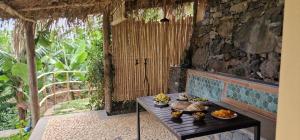a room with a table with food on it at Torre Bella Gardens in Arco da Calheta