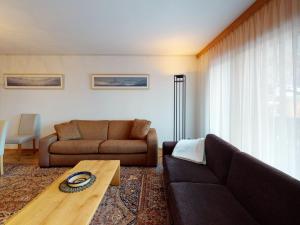 a living room with a couch and a table at Apartment Haus Whymper Edward Suite by Interhome in Zermatt