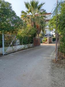 a gate in front of a house with a fence at THE PALM ROOMs in Preveza