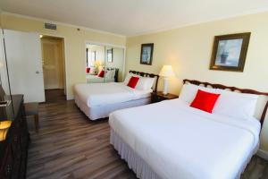 a hotel room with two beds and a television at Alexander 1211 Beachfront Condo with Direct Beach Access, 2 Pools, Sauna, Gym in Miami Beach