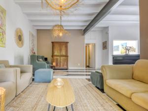 a living room with couches and a table at Holiday Home Ave de Paso by Interhome in Fortiá