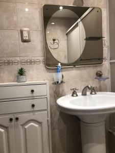 a bathroom with a sink and a mirror at Casa de los Ángeles in San Salvador de Jujuy