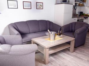 Una sala de estar con dos sofás y una mesa de café. en Holiday Home Müter by Interhome, en Norddeich
