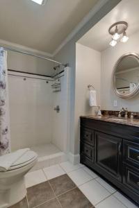 a bathroom with a toilet and a sink and a mirror at Historic Gem! Fire pit, 2 Miles to Broadway! in Nashville