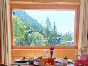 a table with a view of a mountain through a window at Apartment Les Mayens 3-2 by Interhome in Champex