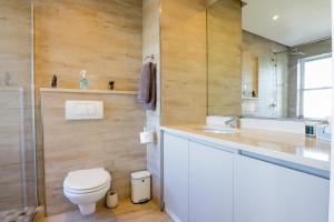 a bathroom with a toilet and a sink at Portico 1006 Beachfront Apartment with Panoramic Views in Cape Town +42 photos