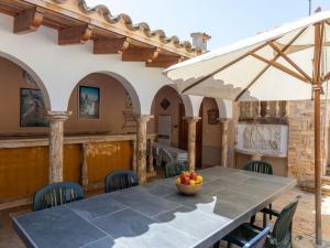 an outdoor patio with a table and chairs at Villa Les Oliveres by Interhome in Llança