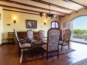 a dining room with a table and chairs at Villa Les Oliveres by Interhome in Llança