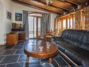a living room with a leather couch and a coffee table at Villa Les Oliveres by Interhome in Llança