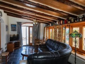 a living room with a leather couch and a table at Villa Les Oliveres by Interhome in Llança