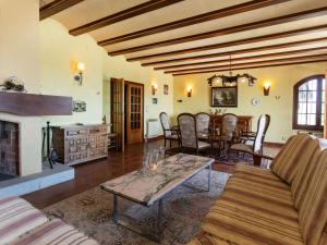 a living room with a fireplace and a table at Villa Les Oliveres by Interhome in Llança +35 photos