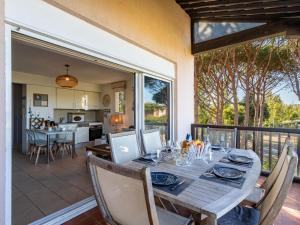 a dining room and kitchen with a table and chairs at Apartment Les Marines-13 by Interhome in La Foux