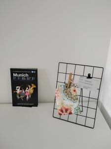 two boxes sitting on a table next to a book at Bright Apartment in Munich Within Sight of Alps in Munich