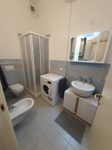 a bathroom with a toilet sink and a washing machine at Casa Pepita in Finale Ligure +19 photos