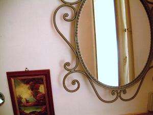 a mirror hanging on a wall next to a picture at Hotel Cestelli in Florence