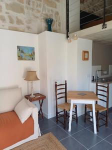 a living room with a couch and a table at Sanibonani in Saint-Mathieu-de-Tréviers +18 photos