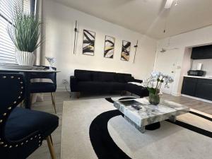 a living room with a couch and a table at Luxury Skyrise Condo Downtown Jax in Jacksonville