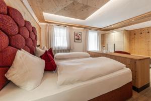 Posteľ alebo postele v izbe v ubytovaní Hotel Ciasa Tamá