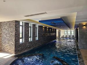 a swimming pool in the middle of a building at Terra 1-Bedroom Sea View Apartment in Boğaz +8 photos