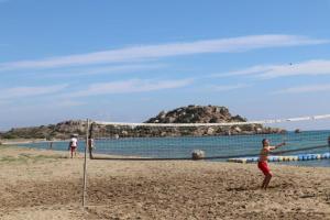 a group of people playing volleyball on a beach at Terra 1-Bedroom Sea View Apartment in Boğaz