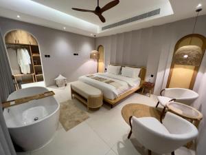 a bedroom with a bed and a tub and a sink at Anara Chalet in Fins +24 photos
