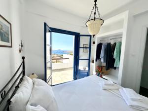 a bedroom with a bed with a view of the ocean at Aegean Paradise, Kythnos, Naousa in Kithnos