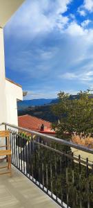 a balcony of a house with a view of the ocean at B&b S'Erbei Niedda Guesthouse in Seùlo