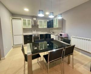 a kitchen with a table and chairs in a room at Markola in Rentería