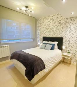 a bedroom with a large bed and a window at Markola in Rentería