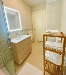 a bathroom with a sink and a shower with a mirror at Markola in Rentería +14 photos