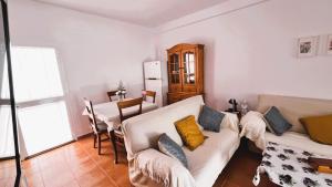 a living room with two couches and a table at Casa adosada en Urbasur ISLANTILLA in Islantilla
