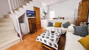 a living room with a couch and a table at Casa adosada en Urbasur ISLANTILLA in Islantilla