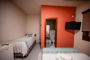 Ένα ή περισσότερα κρεβάτια σε δωμάτιο στο Pousada Hymbe