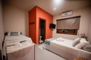 Ένα ή περισσότερα κρεβάτια σε δωμάτιο στο Pousada Hymbe