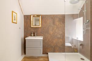 a bathroom with a sink and a shower at Furzen Farmhouse - Quiet Alternative to a Hotel in Cirencester +16 photos