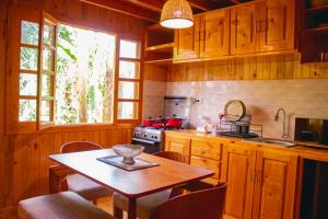 a kitchen with a table and a table and a window at Palo Alto Lodge in Oxapampa