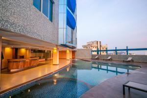 a swimming pool in the middle of a building at Parrot Hotel Arusha in Arusha