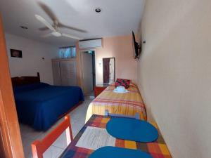 Postel nebo postele na pokoji v ubytování Hotel Maria's Nicte Ha