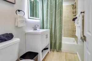 a white bathroom with a sink and a shower at Albuquerque Retreat with Hot Tub - Central Location! in Albuquerque +16 photos