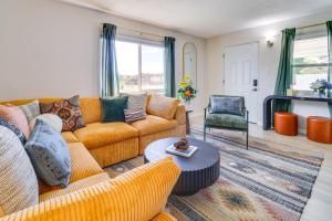 a living room with two couches and a table at Central Albuquerque Getaway with Hot Tub and Grill! in Albuquerque