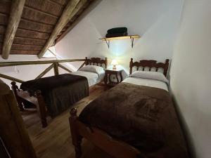 a bedroom with two beds in a room with a ceiling at Cabañas del Paraiso in Colón