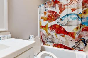 a bathroom with a shower curtain with a toilet at Peabody House in Wilmington +16 photos