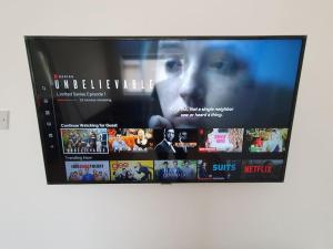 a television screen with a bunch of movies at Crash pad in Luton Town in Luton