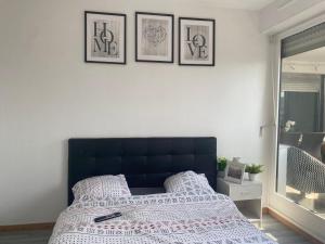 a bedroom with a bed and three pictures on the wall at Appartement 3 Chambres Evry plein Centre ville in Évry-les-Châteaux