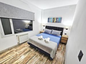 a bedroom with a bed with two towels on it at Las Victorias Suites Bariloche in San Carlos de Bariloche