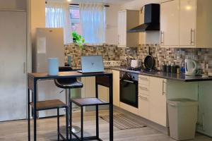 a kitchen with a table with a laptop on it at Fabulous 1Bed Apt with Balcony in Central Birmingham in Birmingham