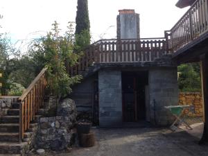 a house with a staircase leading to a door at Agriturismo "La Rosa Canina" in Lerici